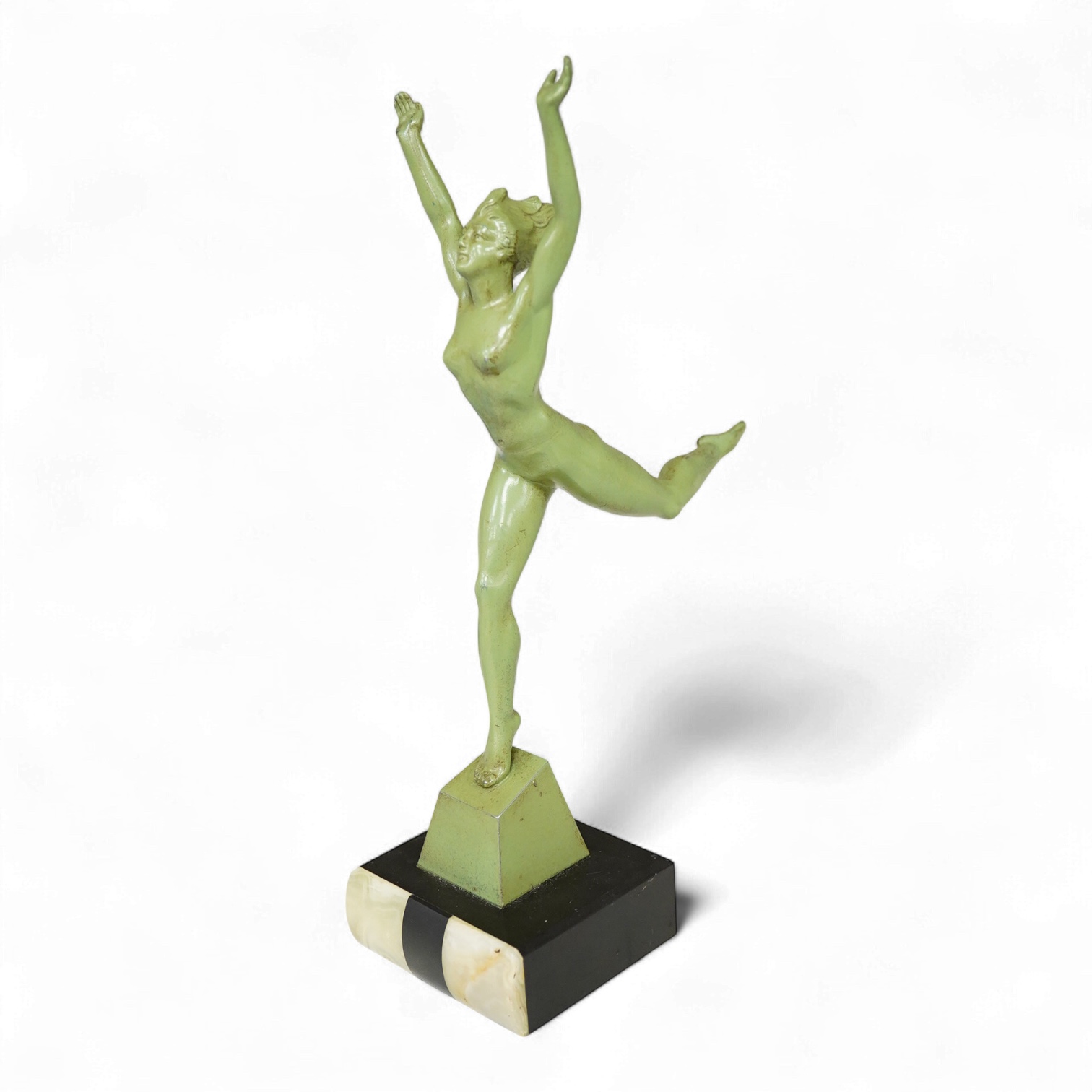 An Art Deco patinated spelter figurine of a nude dancer raised on black and green onyx base, 29cm high